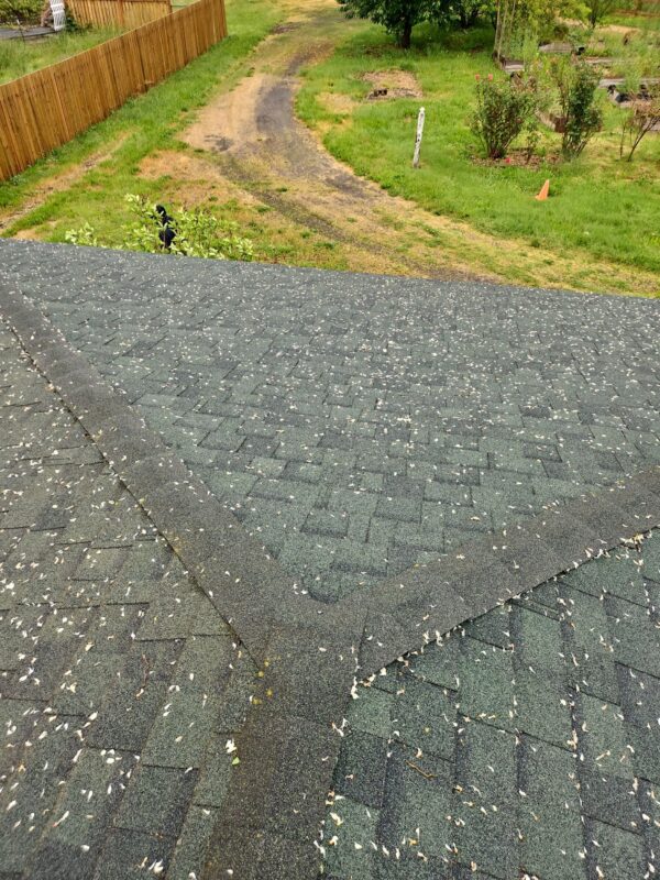 Detailed view of chimney flashing and ridge vent on new roof