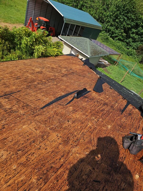 Exposed roof decking showing damage before new installation