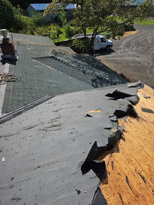 Old shingles being removed during roof installation in Sherwood OR
